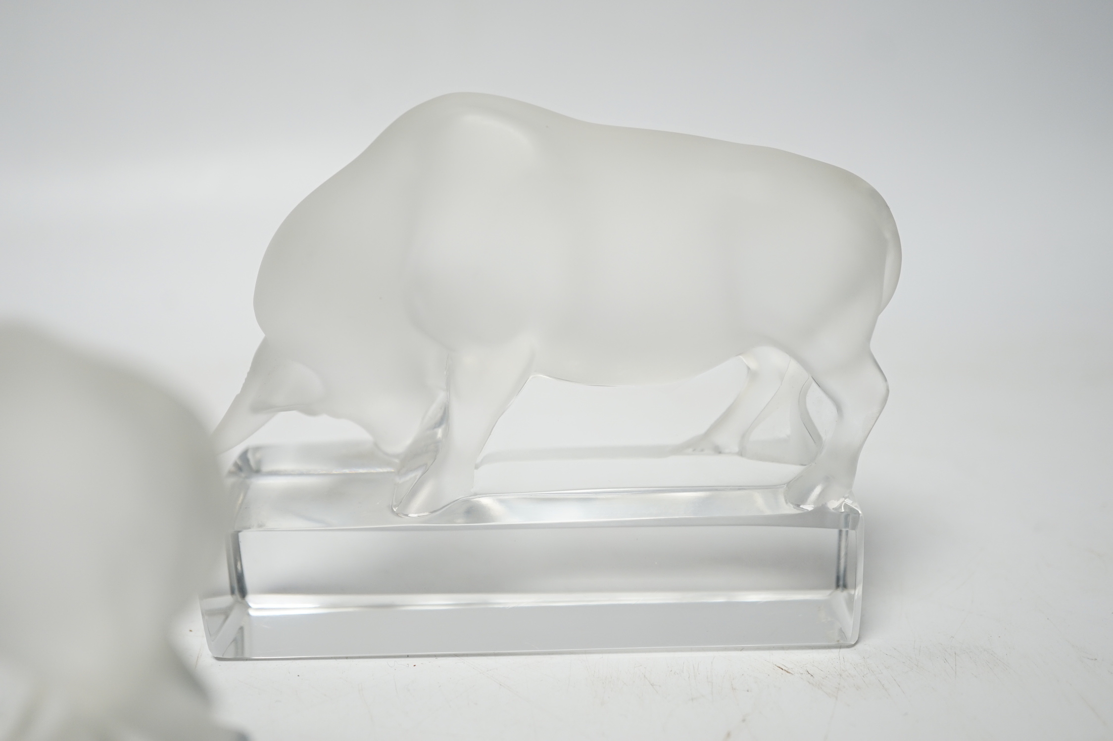 Rene Lalique, two frosted glass paperweights modelled as a bull, signed ‘Lalique France’ to base, 9cm high